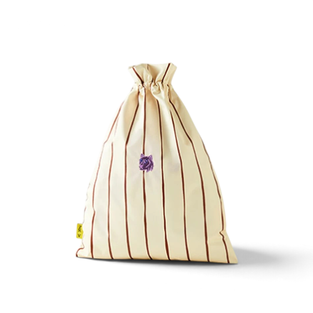 One Two Play Canyon Sunset laundry bag for kids with cream and brown vertical stripes and a small purple detail.