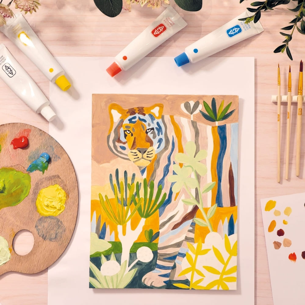 Colorful painting of a tiger on a wooden panel with art supplies around.