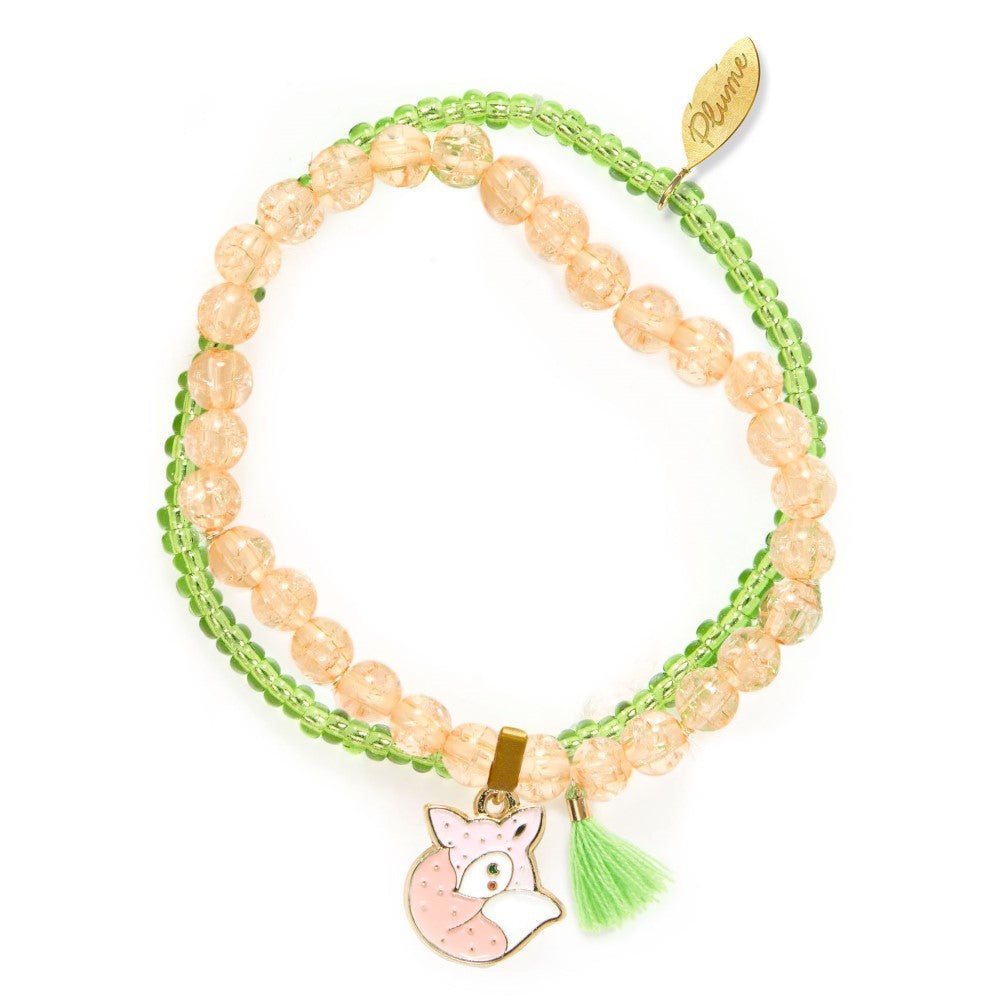 Multistrand bracelet with peach beads, green accents, and a fox charm on a white background