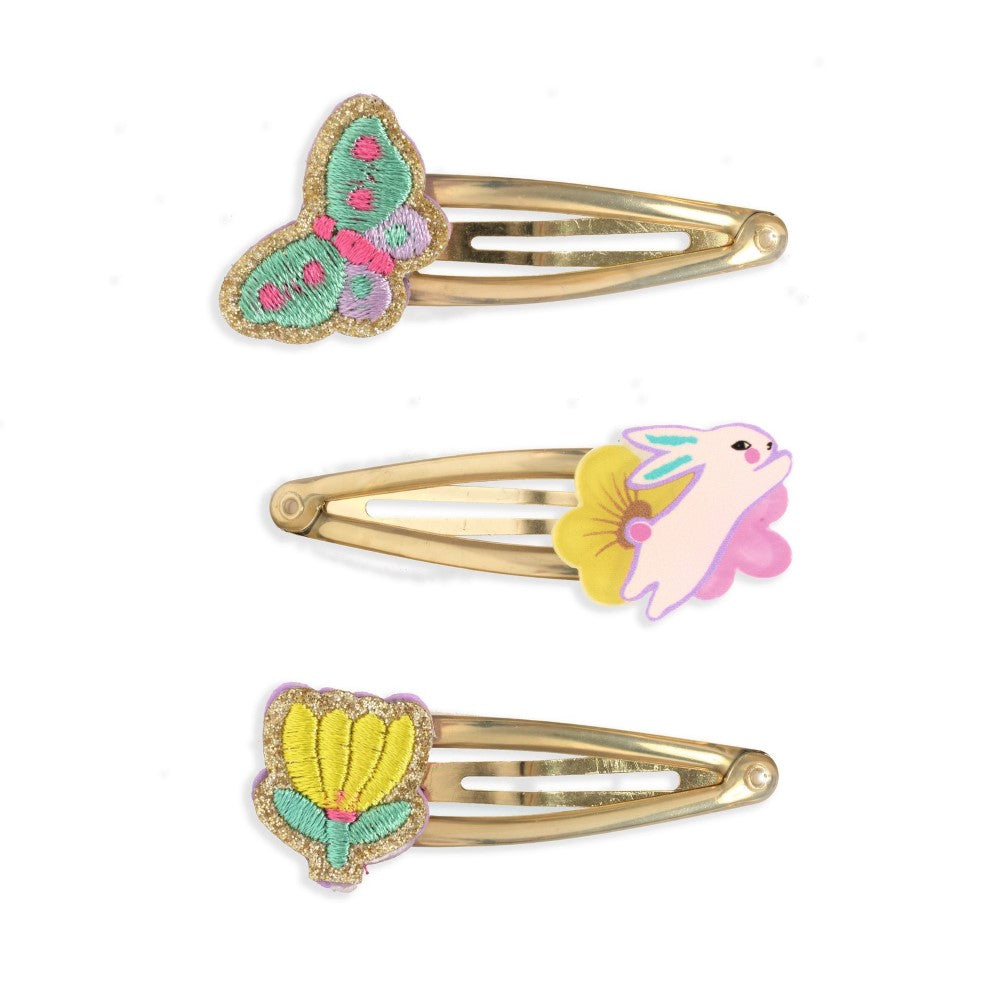 Three decorative hair clips with butterfly, fish, and shell designs on a white background.