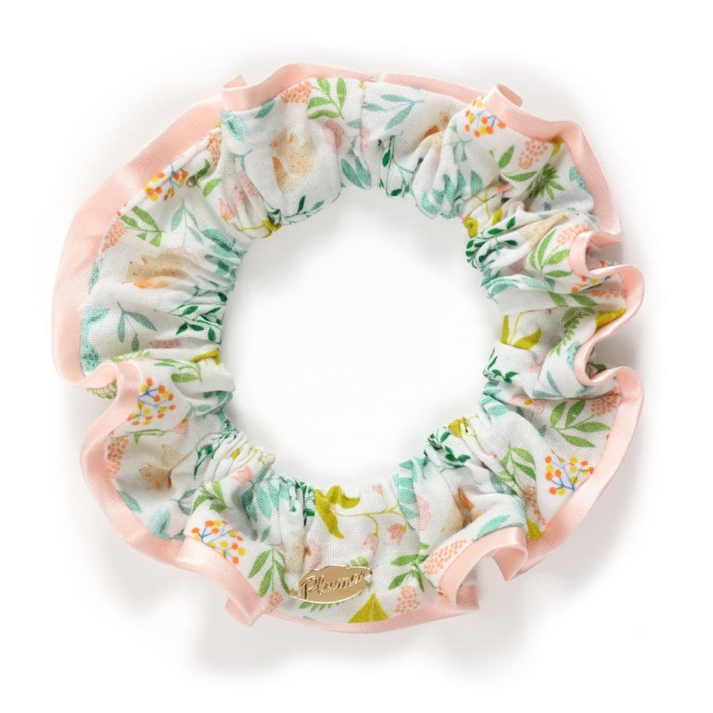 Floral scrunchie with pink trim on a white background