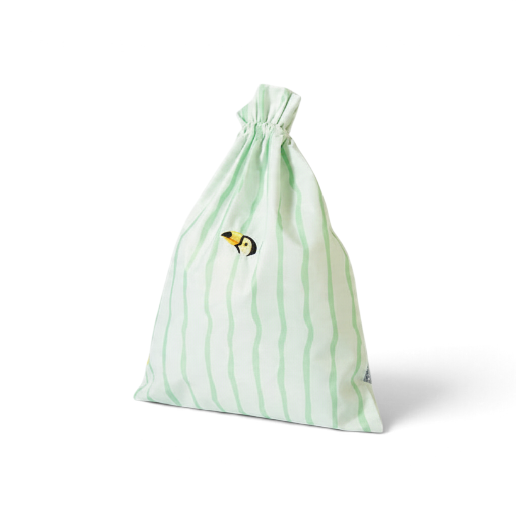 One Two Play Mint Mambo laundry bag for kids with green wavy stripes and a small toucan bird detail.