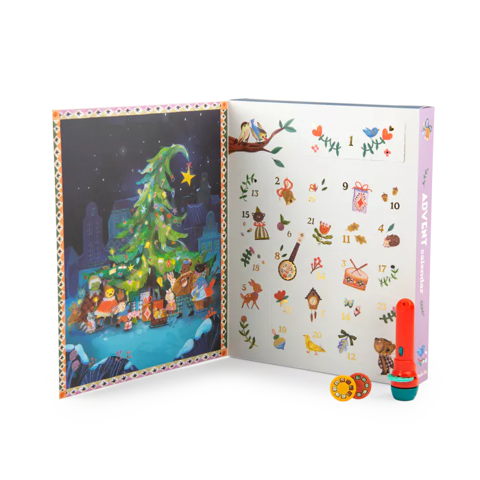 Open book with Christmas-themed illustrations and a colorful pen on a white background