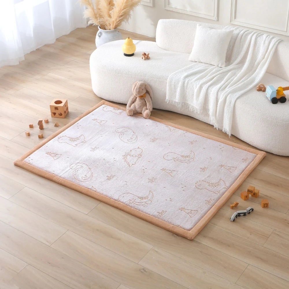Children's play area with a rug featuring animal prints on a wooden floor.