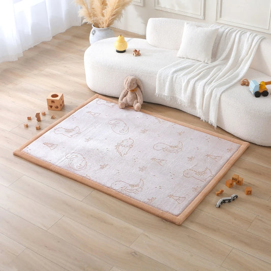 Children's play area with a rug featuring animal prints on a wooden floor.