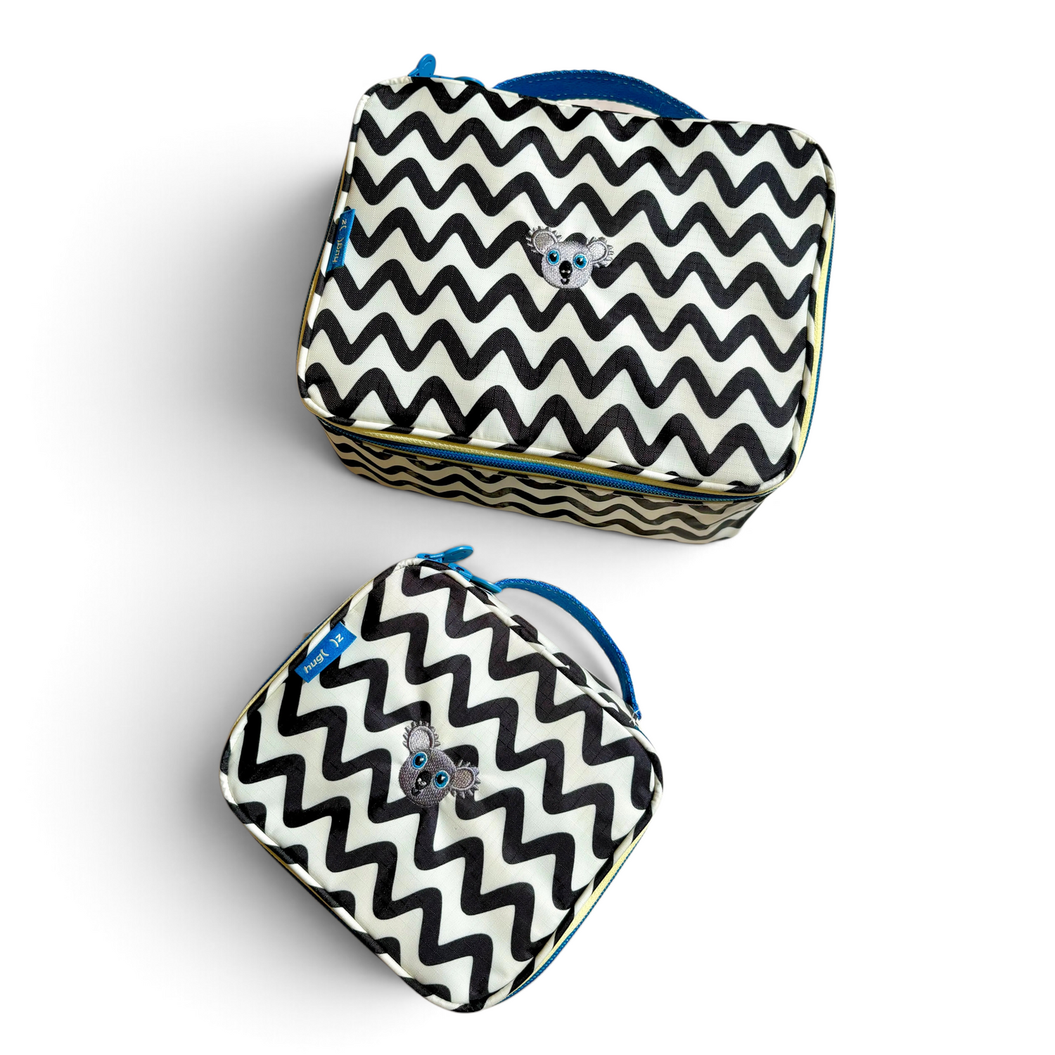 One Two Play medium and small water-resistant toiletry bags with a black and white chevron pattern and koala patch.
