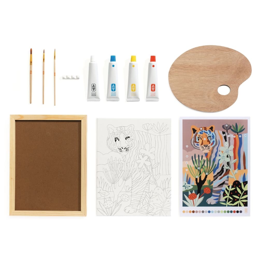 Art supplies including paintbrushes, paint tubes, a palette, a framed picture, and coloring books on a white background.