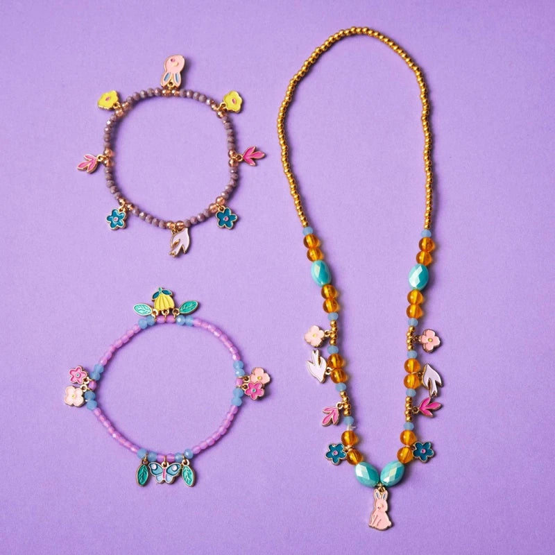 Set of colorful necklaces and bracelets on a purple background