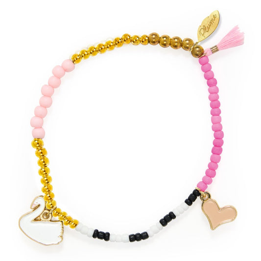 Bracelet with pink and gold beads, swan charm, and heart charm on a white background