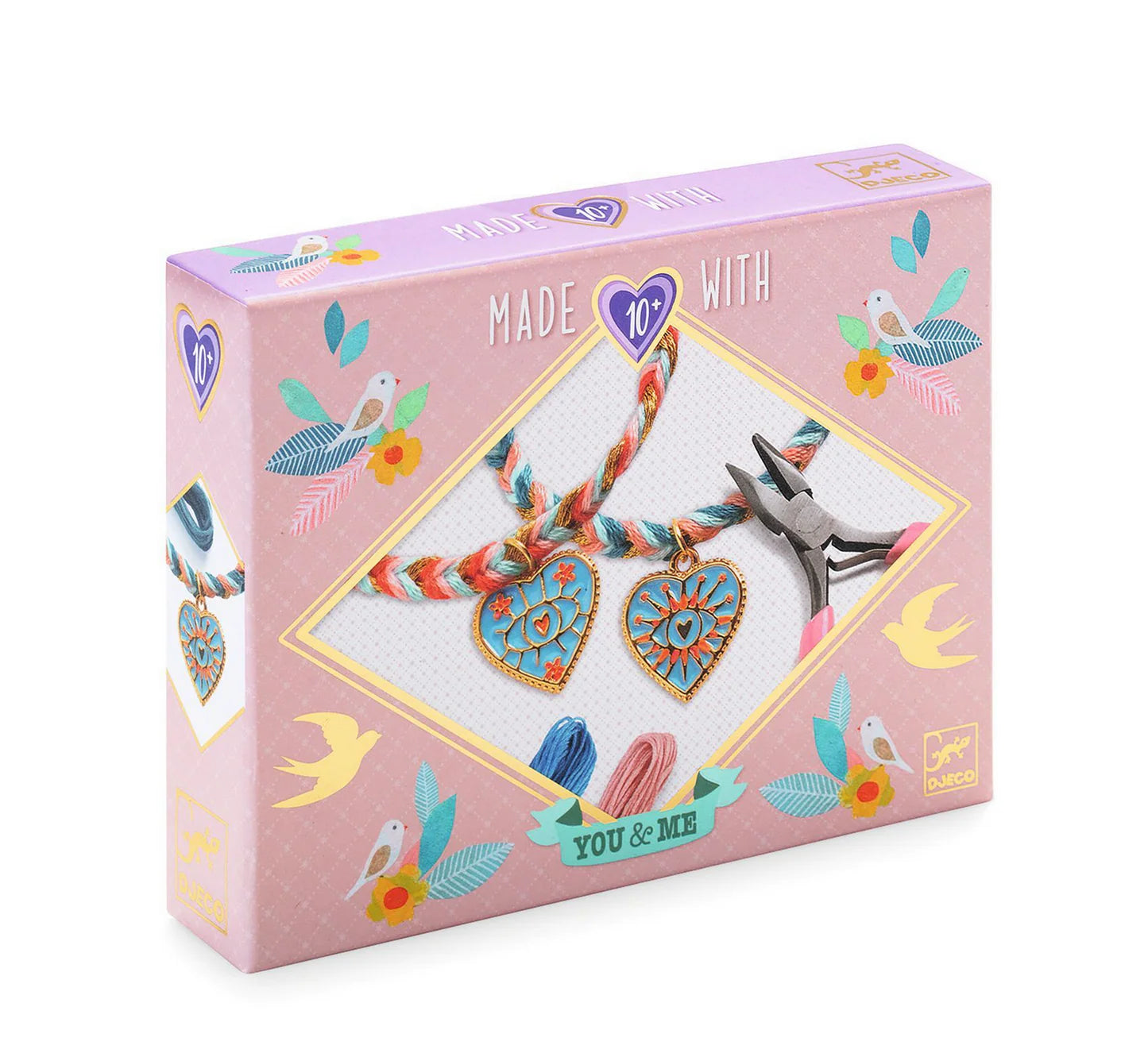 Jewelry set packaging with heart-shaped charms and a bracelet on a pink background
