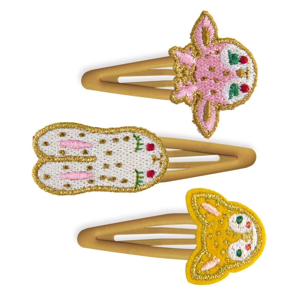 Three decorative hair clips with embroidered designs on a white background