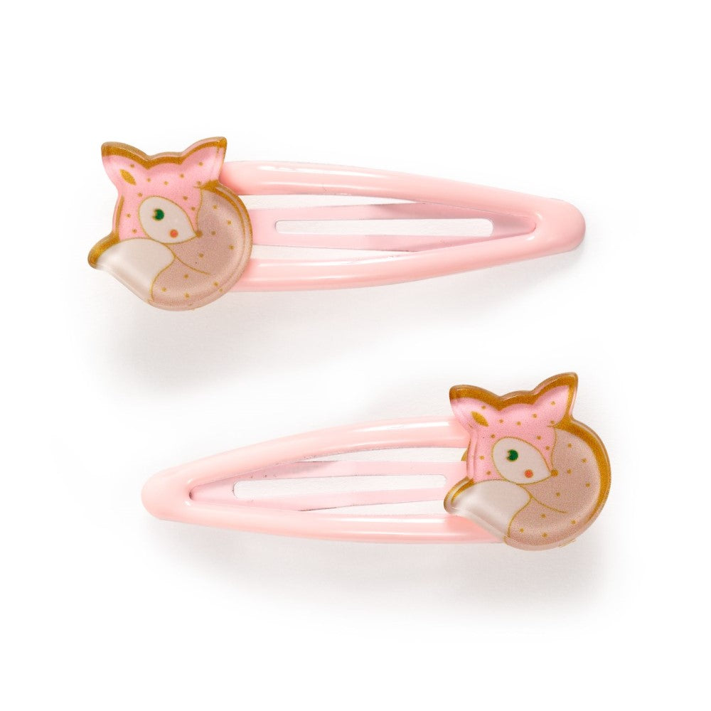 Two pink hair clips with fox designs on a white background