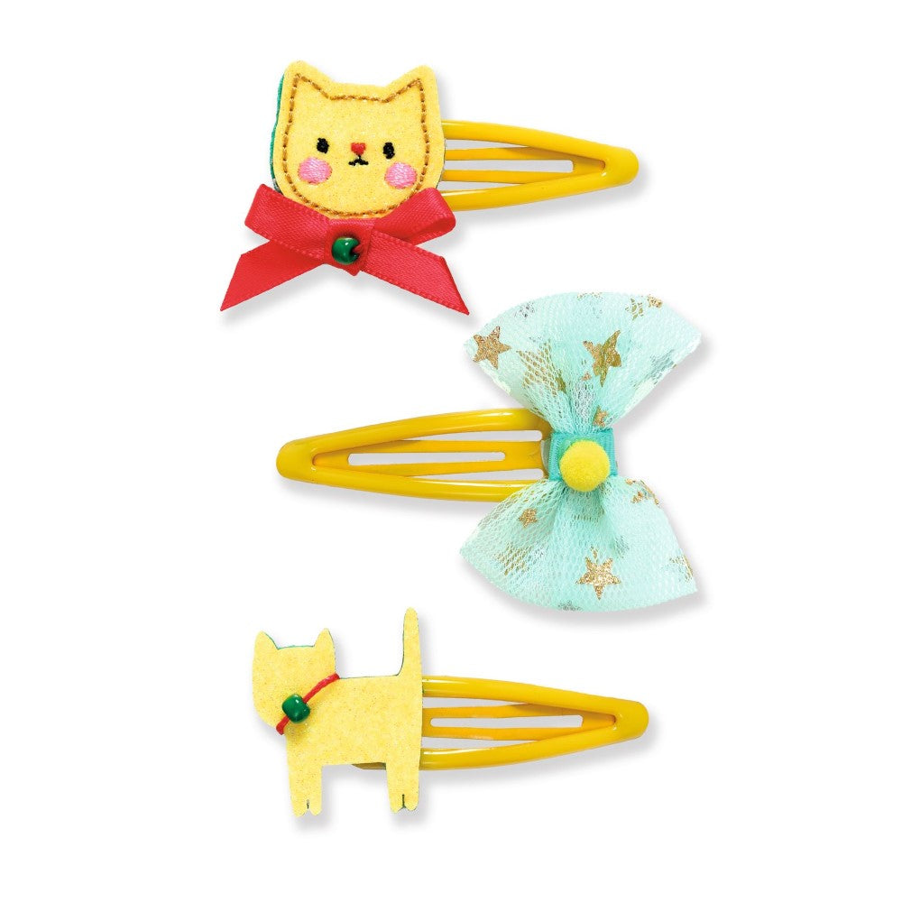 Set of three colorful hair clips with cat designs on a white background