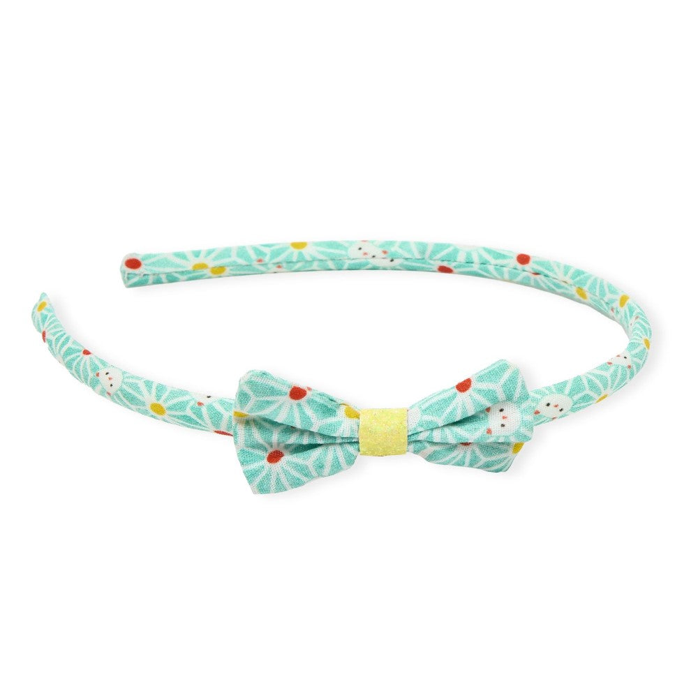 Floral-patterned headband with a bow on a white background