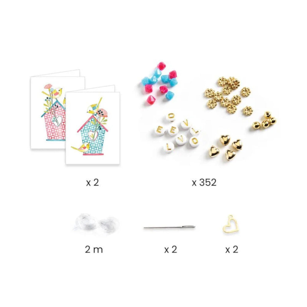 Collection of small craft items including beads, letters, and decorative elements on a white background.