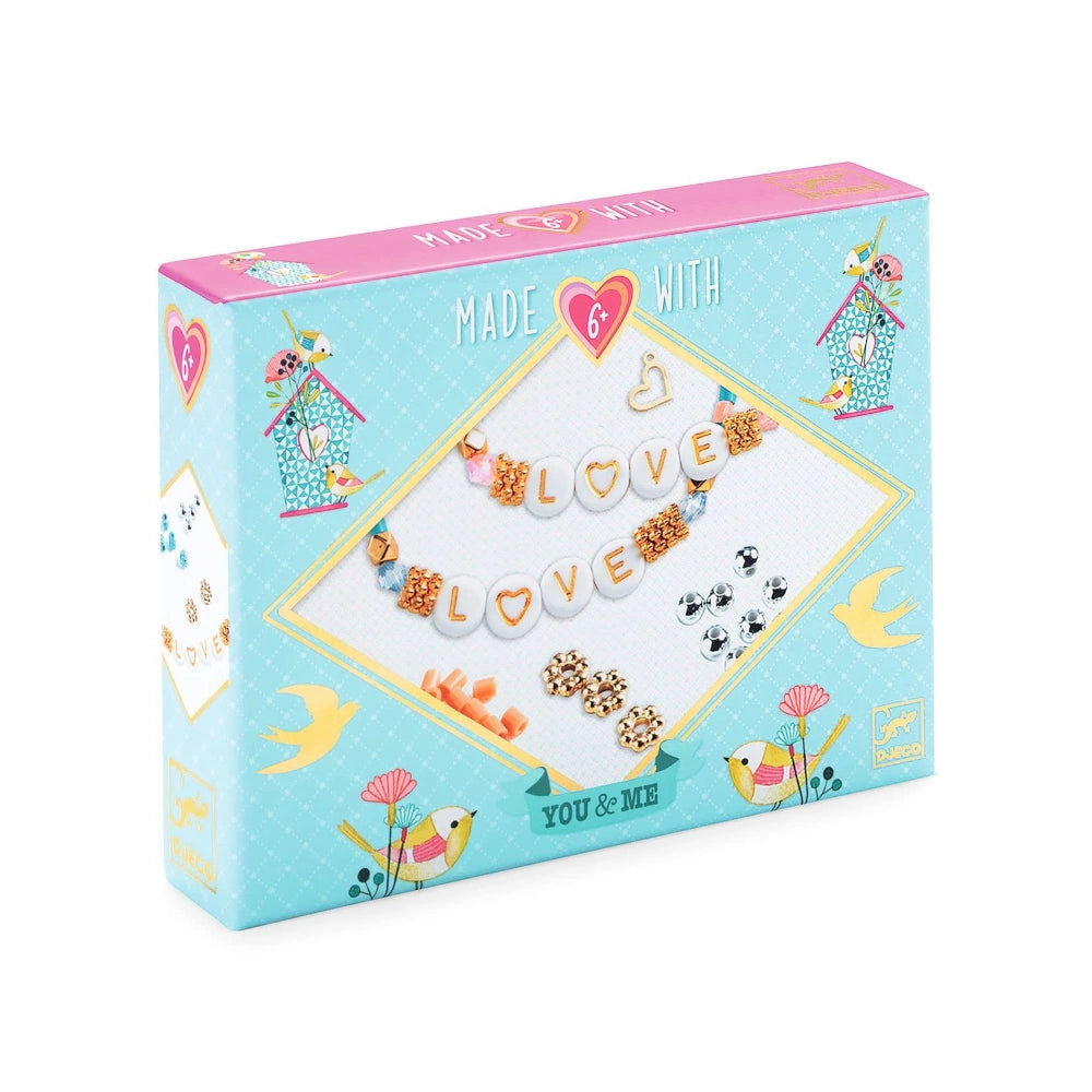 Box of jewelry making kit with decorative elements on a white background