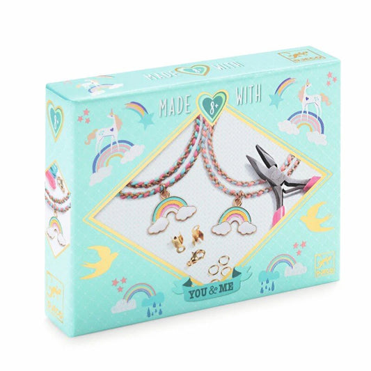 Jewelry set packaging with rainbow and unicorn designs on a light blue background