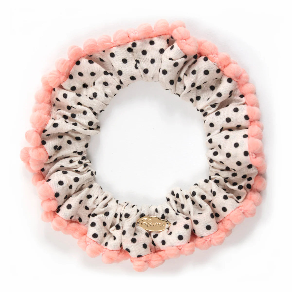 Polka dot scrunchie with pink trim on a white background