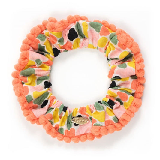 Floral patterned scrunchie with orange border on a white background
