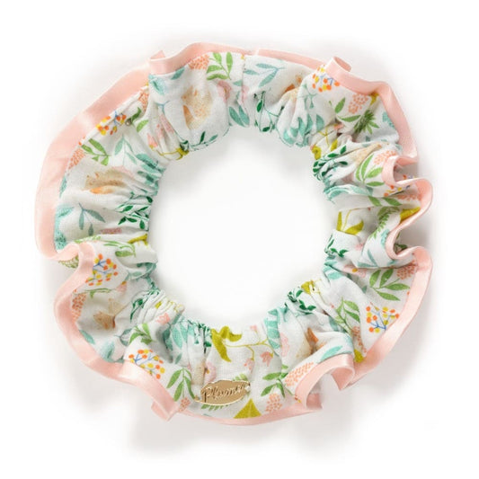 Floral scrunchie with pink trim on a white background