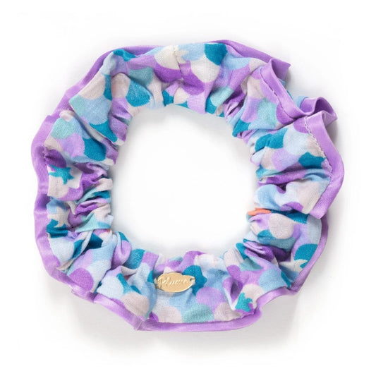 Multicolored scrunchie with a small gold tag on a white background