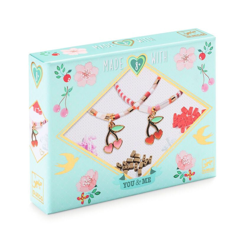 Box of jewelry with floral designs and 'Made with Love' text on a white background