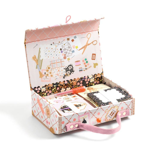 Decorative stationery set with notebooks and stationery items in a patterned box on a white background