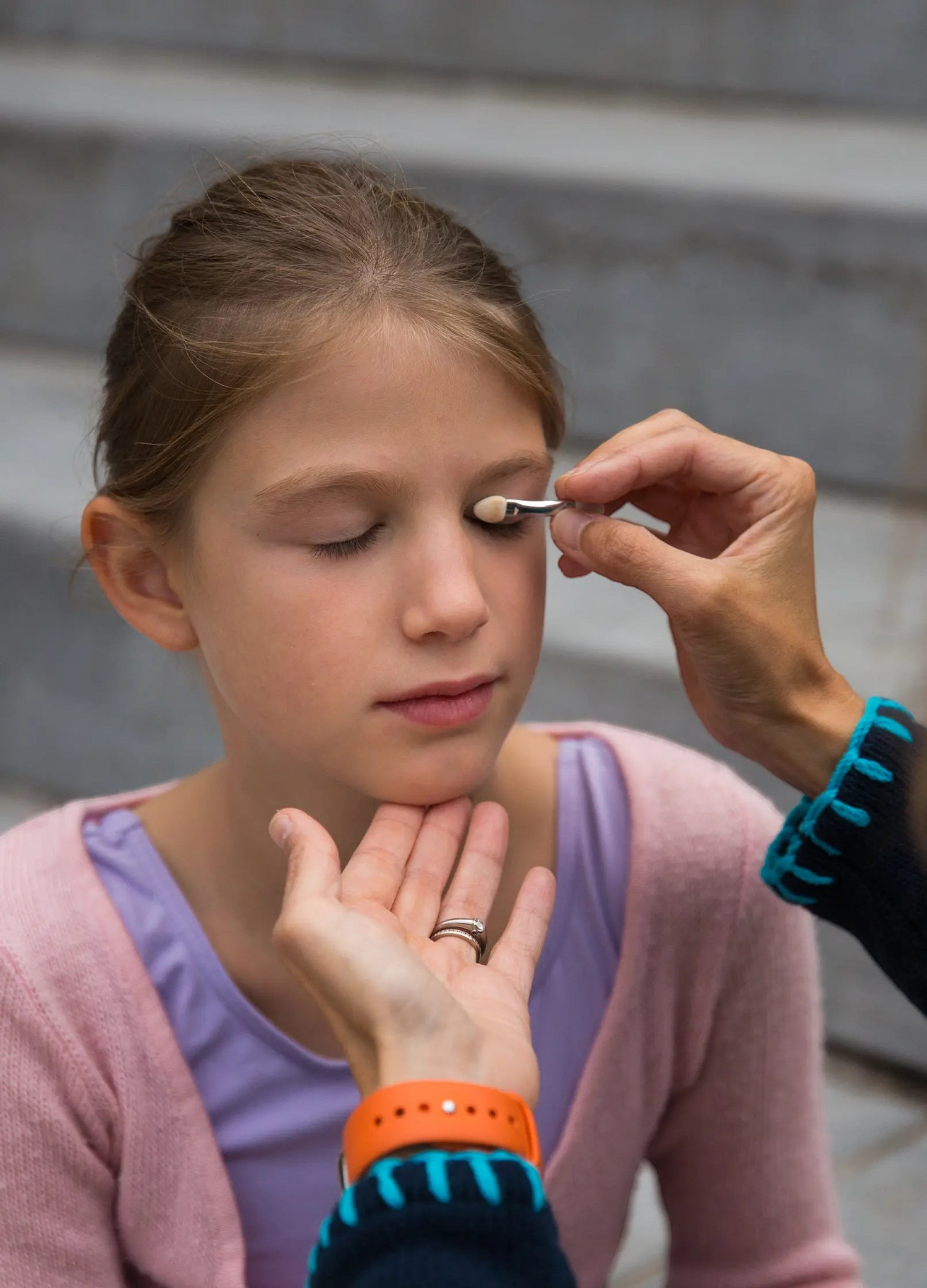 One Two Play winter eyeshadow set being applied to a young girl's eyelid with a soft double-ended applicator