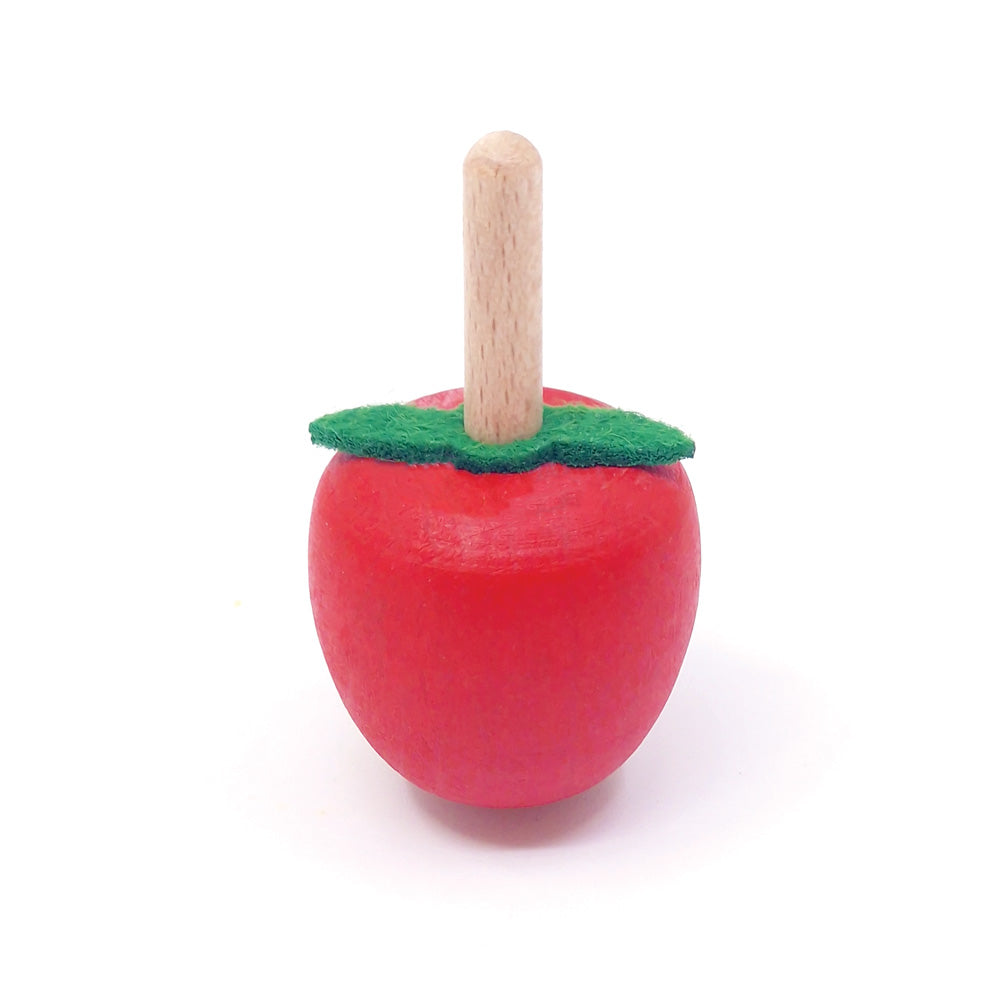 Wooden toy apple with a stick on a white background