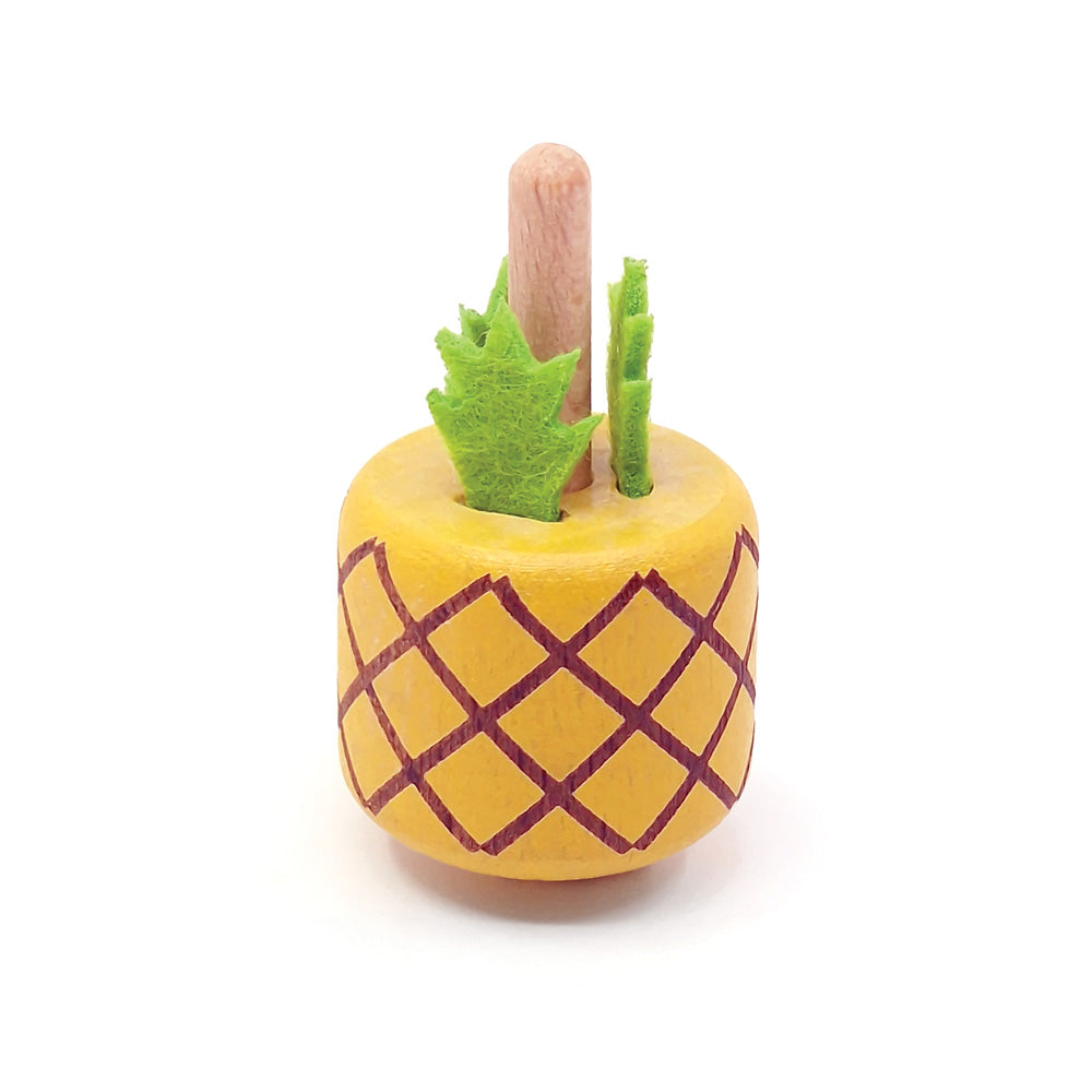 Toy pineapple with a stick on a white background